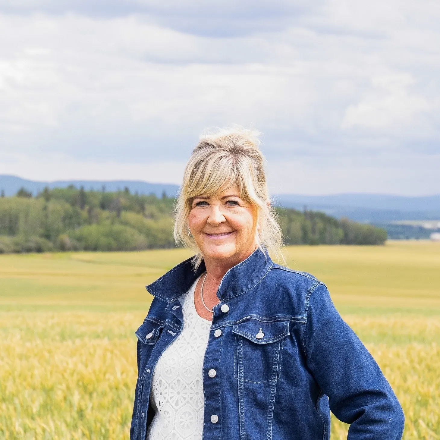 Nyla LePine standing in a grassy field in the Peace Country