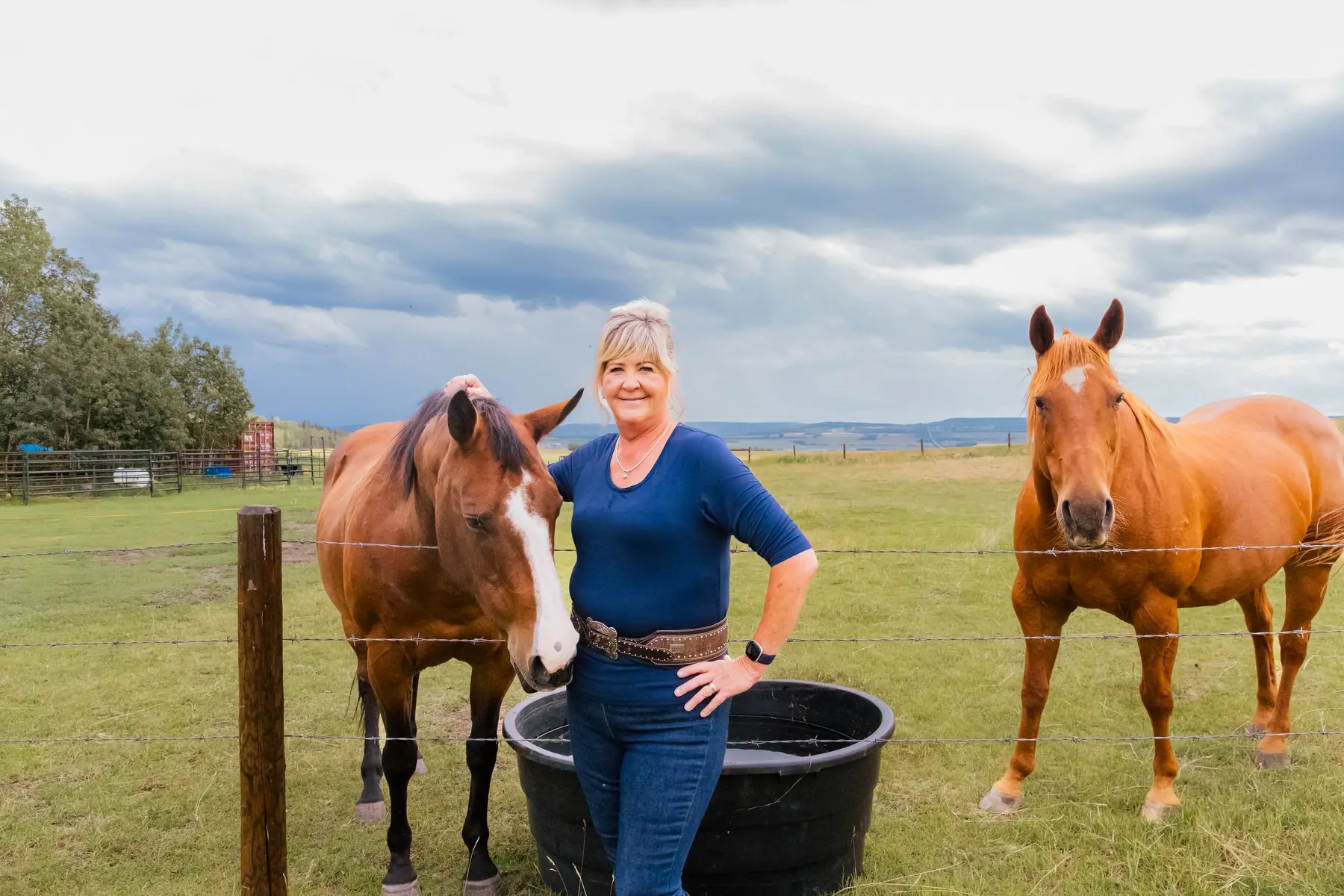 Nyla LePine with two horses on a Peace Country ranch