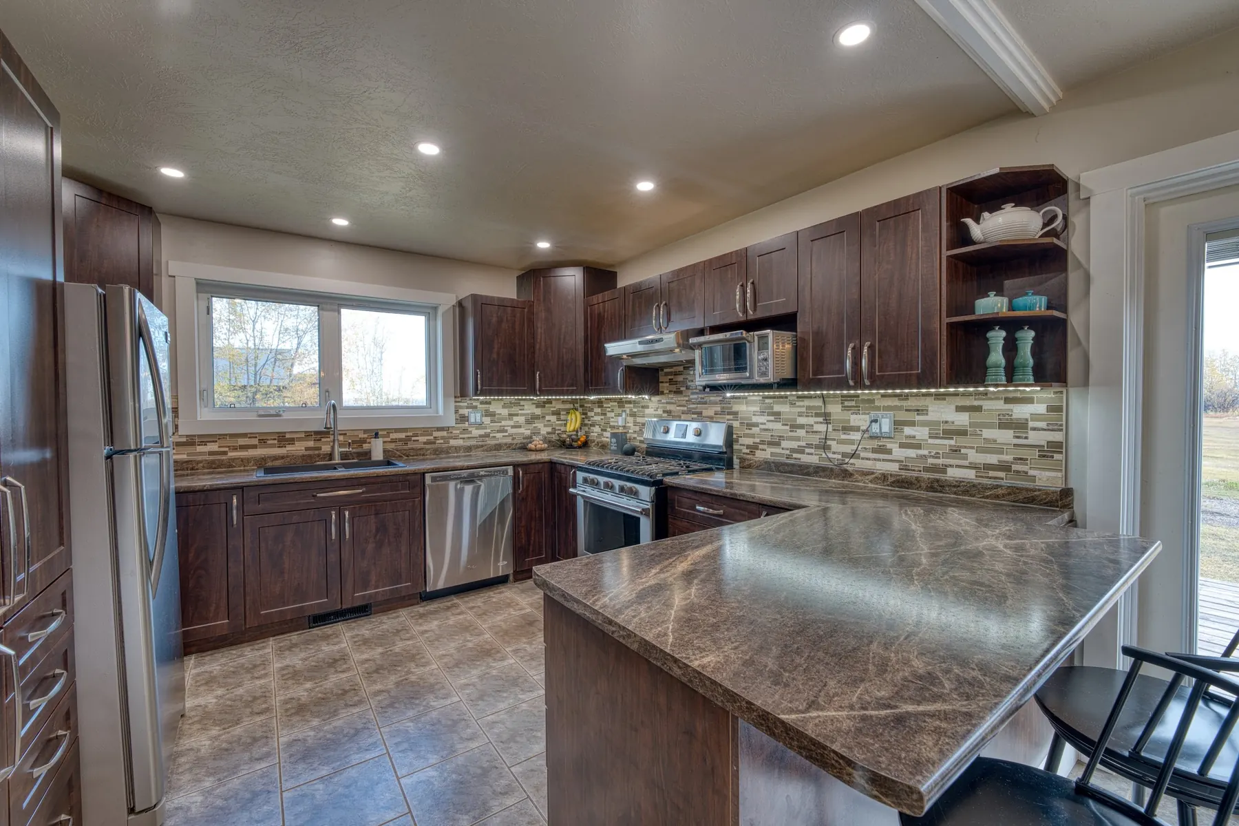 Bright, modern kitchen with white cabinets and marble island